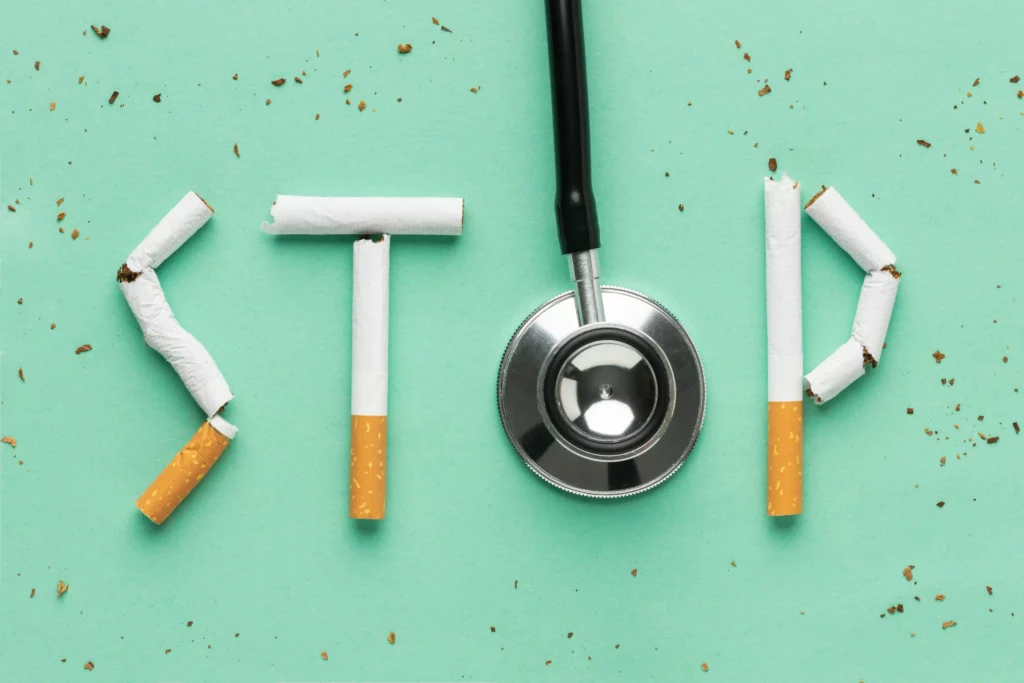 Stethoscope and cigarettes form the word "STOP" on a green background.